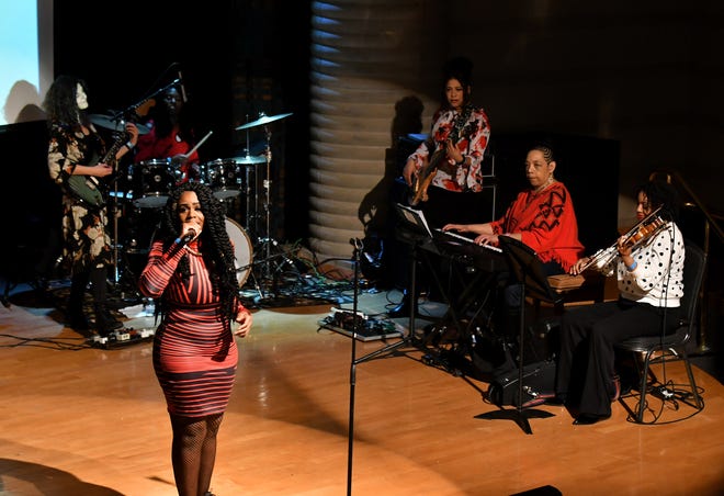 Princess Covergirl Taylor performs with the All Woman Band at the Women in Hip Hop event at the Charles H. Wright Museum of African American History in Detroit, March 3, 2019.  Band members are, from left, Sarah Rez on guitar, Aisha Ellis on drums, Emily Rogers on bass, Pamela Wise Harrison on keys and Ashley Nelson on violin.