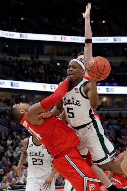 Michigan State's Cassius Winston (5) is drives against Ohio State's Andre Wesson (24) during the second half.