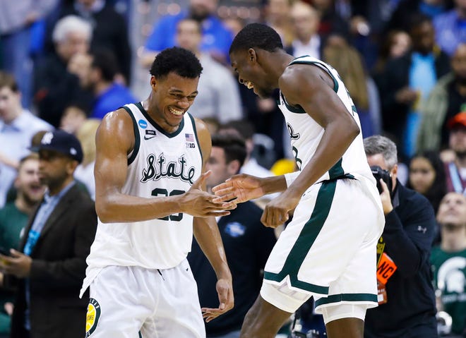 Michigan State forward Xavier Tillman, left, and teammate Gabe Brown, right, celebrate after the team's 80-63 win over LSU.