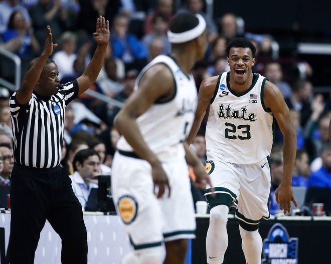 Michigan State forward Xavier Tillman (23) reacts to scoring against LSU during the first half.