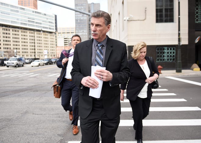 Former UAW Vice President Norwood Jewell, center, leaves U.S. District Court in Detroit on April 2 after pleading guilty to breaking federal labor laws. He was sentenced to 15 months in federal prison.