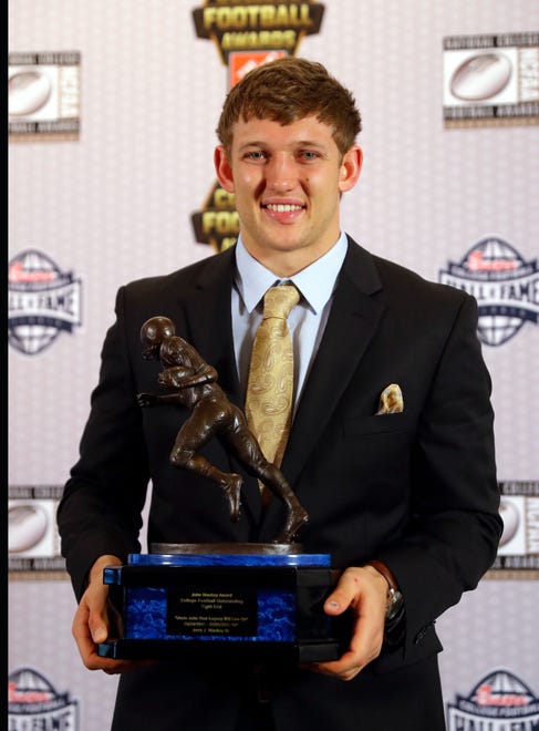 Iowa's T.J. Hockenson poses with the trophy after winning the John Mackey Award as top tight end in college football, in December 2018.