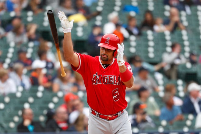 Los Angeles Angels slugger Albert Pujols tosses his bat after hitting a solo home run in the third inning Thursday, collecting his 2,000th career RBI.