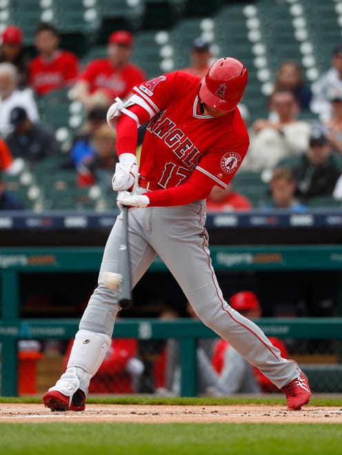 The Angels' Shohei Ohtani hits an RBI single in the first inning.