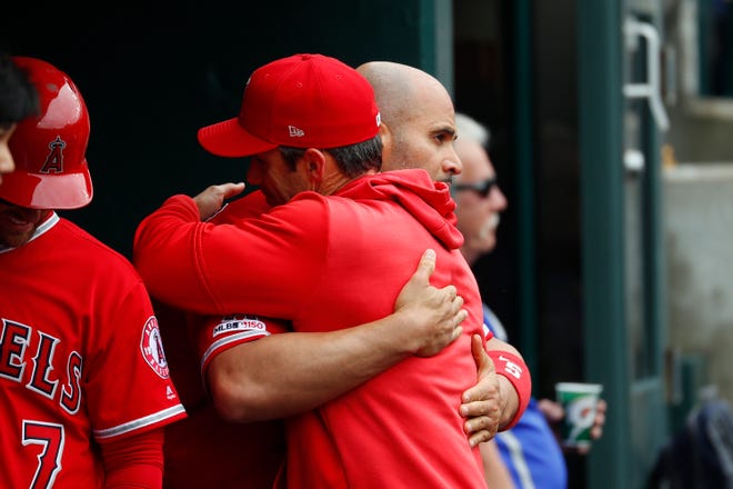 Los Angeles Angels' Albert Pujols hugs manager Brad Ausmus after hitting a solo home run in the third inning. The home run gave Pujols his 2,000th career RBI.