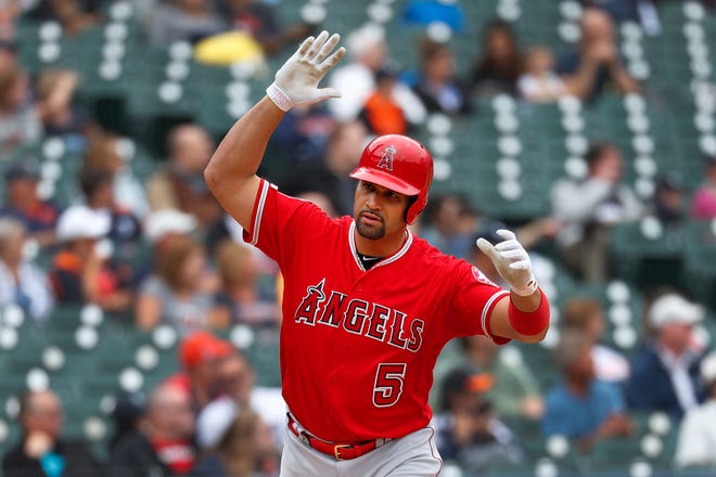 The Angels' Albert Pujols tosses his bat after hitting a solo home run in the third inning, driving in his 2,000th career run.