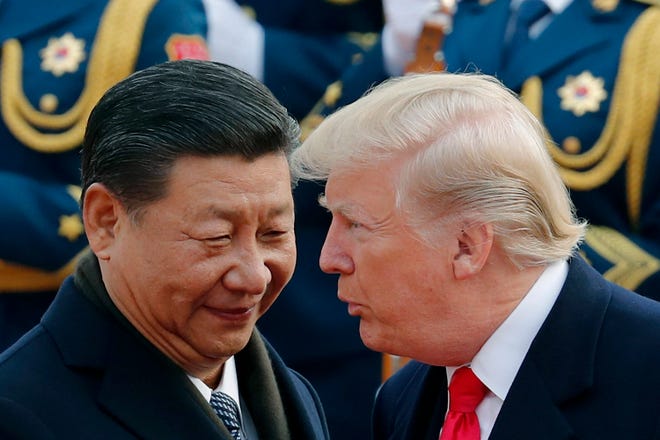 FILE - In this Nov. 9, 2017, file photo, U.S. President Donald Trump, right, chats with Chinese President Xi Jinping during a welcome ceremony at the Great Hall of the People in Beijing. The United States and China are scheduled Thursday, May 9, 2019, to resume talks to try to back off an escalating trade war. (AP Photo/Andy Wong, File)