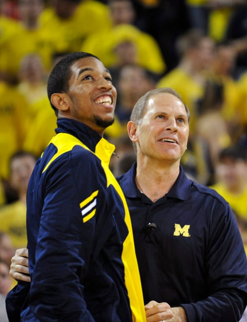 Michigan sophomore Darius Morris and head coach John Beilein celebrate the Wolverines' selection as a No. 8 seed in the West Regional of the NCAA men's basketball tournament during a selection show event at Crisler Arena in Ann Arbor on Sunday, March 13, 2011.