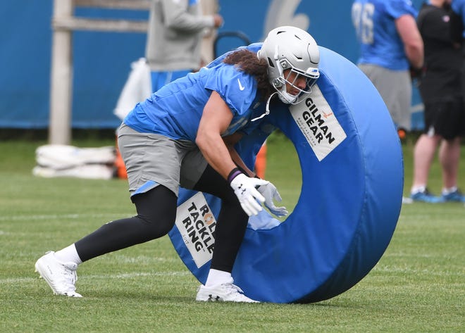 Lions linebacker Jahlani Tavai works with a ring obstacle during drills.