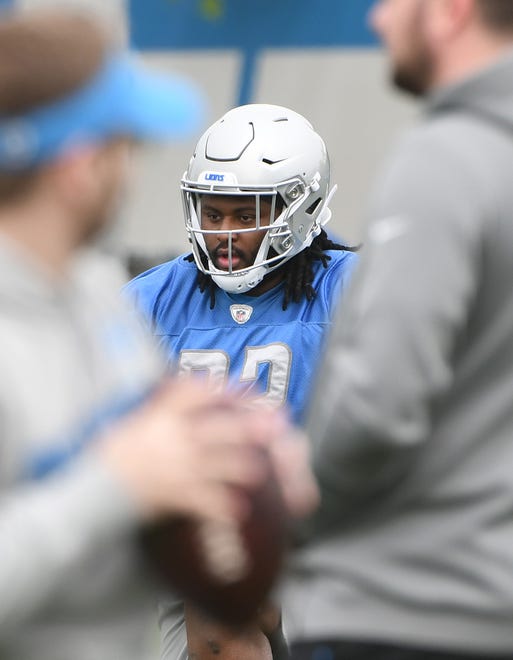 Lions defensive tackle P.J. Johnson warms up at the start of practice.
