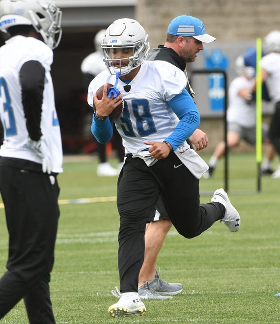 Lions running back Ty Johnson runs out a play during practice.