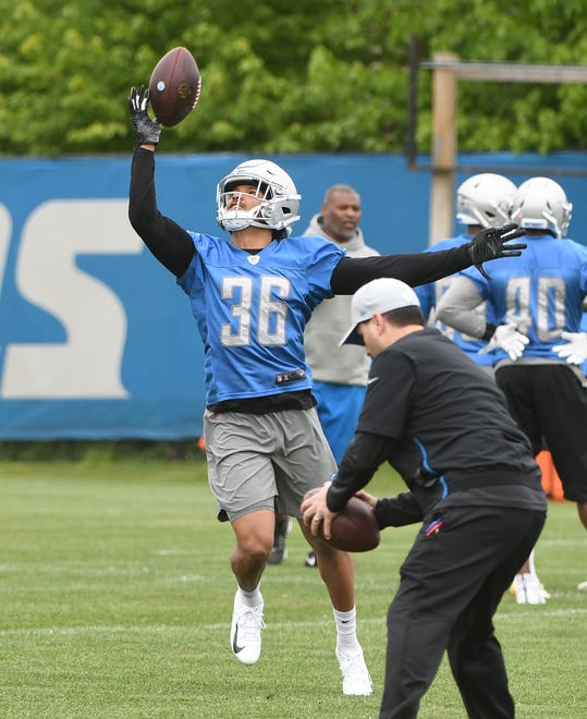 Lions cornerback Andre Chachere pulls down a pass with one hand during drills.