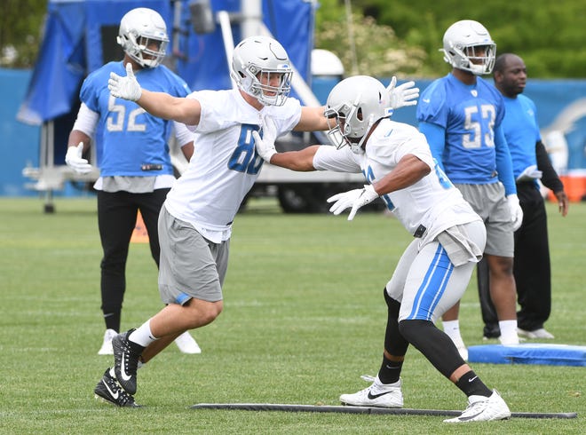 Lions tight end T.J. Hockenson works against tight end Jerome Cunningham during drills.