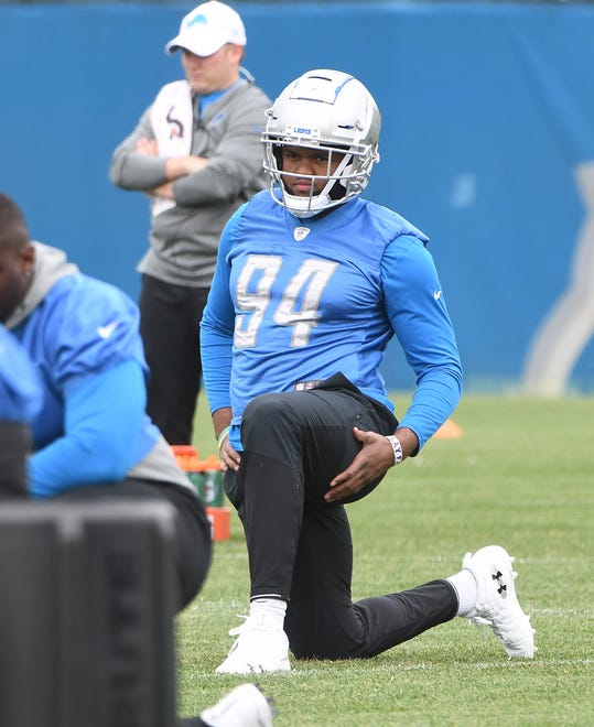 Lions defensive end Austin Bryant stretches out at the start of practice.