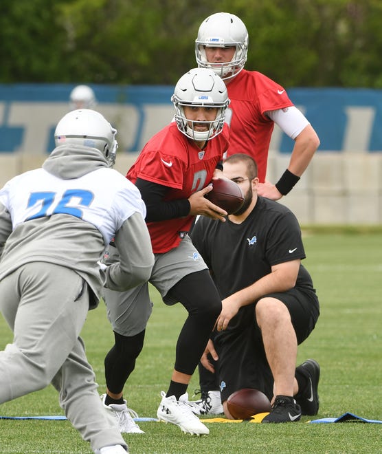 Lions quarterback Tom Savage looks to handoff to running back C.J. Anderson.