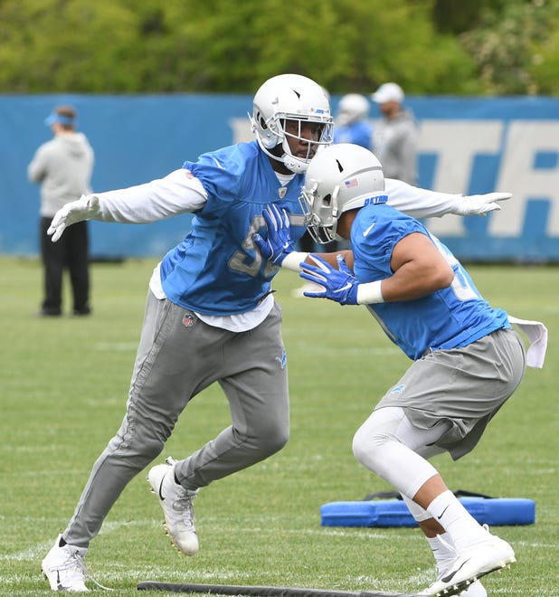 Lions defensive end Eric Lee works against linebacker Anthony Pittman during drills.