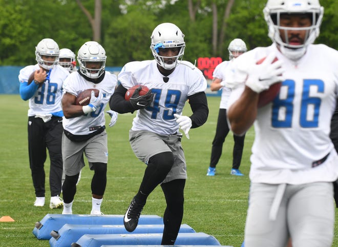 Lions safety C.J. Moore works his way through obstacles during drills.