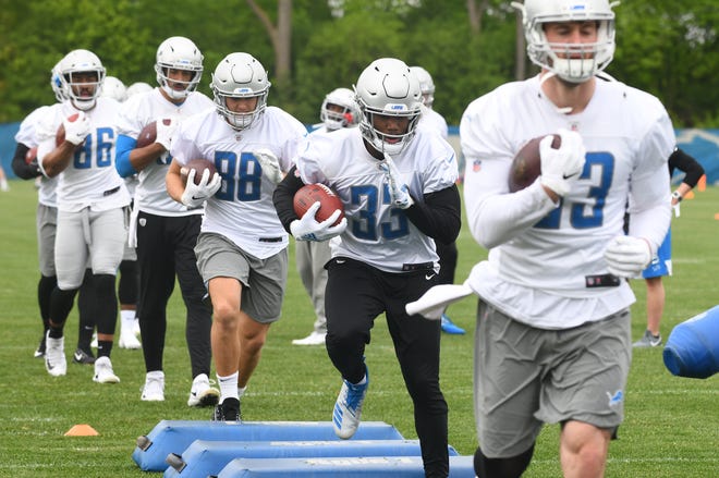 Lions running back Kerryon Johnson followed by tight end T.J. Hockenson during drills.