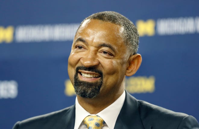 Juwan Howard smiles during his introduction as Michigan's new men's basketball coach, Thursday, May 30, 2019 in Ann Arbor, Mich. The former member of the Fab Five has a five-year contract that will pay him $2 million in his first year. The former Miami Heat assistant coach replaces John Beilein, who left to coach the Cleveland Cavaliers.