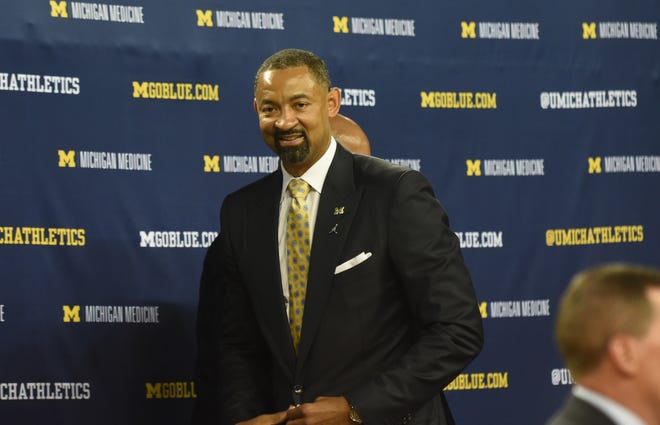 Juwan Howard walks off the stage after speaking to the news media at the Crisler Center in Ann Arbor