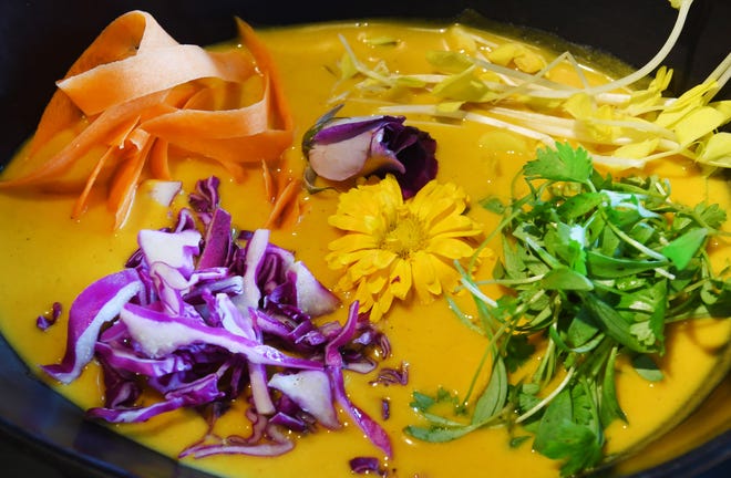 The colorful Spring coconut soup with red curry and spring vegetables.