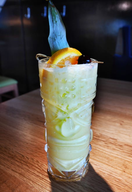 The Pain Killer consisting of Cane rum, house made coconut turmeric and orange and pineapple juices.