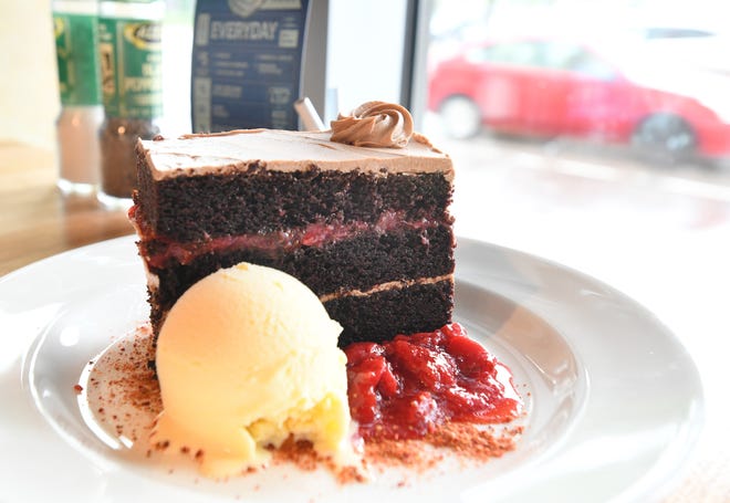 Chocolate cake with fresh strawberry filing, house churned vanilla ice cream and strawberry dust.