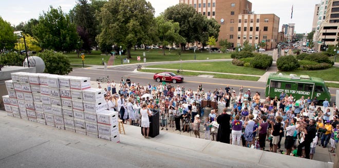 In this July 6, 2018, file photo, volunteers from around Idaho belonging to various organizations gather on the steps of the Idaho Capital Building after a signature campaign gathered over 70,000 voter signatures petitioning for an initiative for Medicaid expansion be placed on the November election ballot.