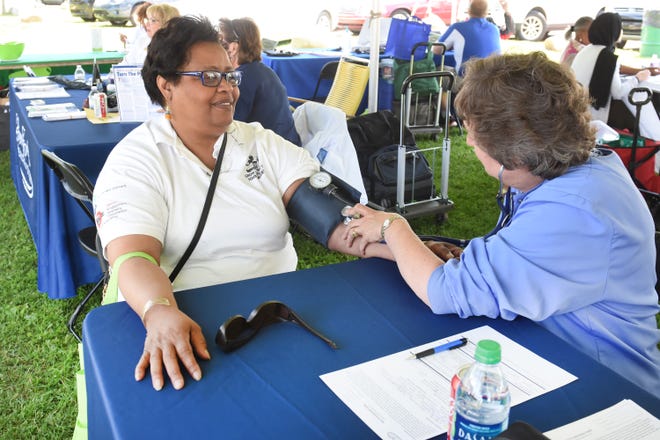 Viruth Watts (left), 59, of Detroit, gets a blood pressure screening by Diane Upplegger of Henry Ford Hospital in Wyandotte during the Wayne County Senior Services Senior Fun Fest on Saturday, June 22, 2019.