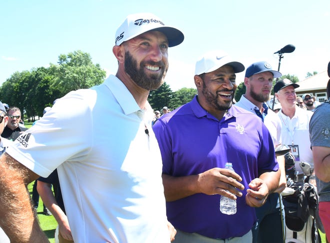 Teammates Dustin Johnson and Jerome Bettis chat before the start of the AREA 313 Celebrity Challenge at the Detroit Golf Club in Detroit, Michigan on June 25, 2019.