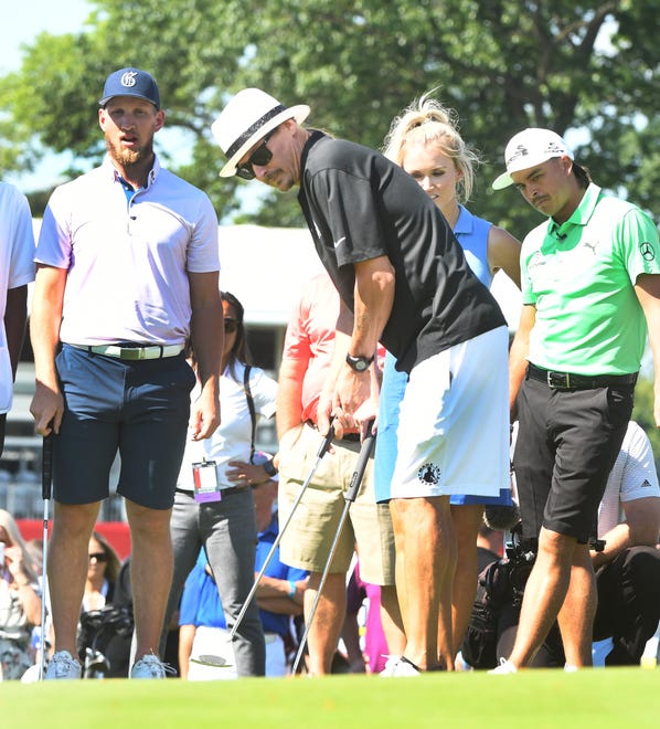Kid Rock putts on the 15th green with Red Wing Justin Abdelkader, golfer Blair O'Neal and golfer Rickie Fowler looking on.