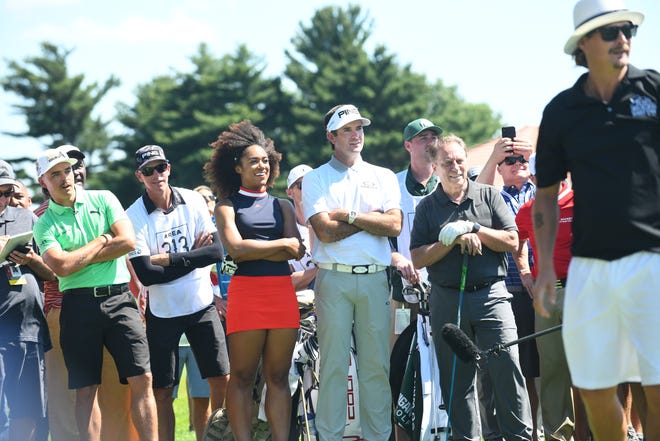 Golfer Rickie Fowler, golfer Troy Mullins, golfer Bubba Watson and Michigan State basketball coach Tom Izzo watch as rocker Kid Rock drives off the 15th tee during the AREA 313 Celebrity Challenge at the Detroit Golf Club in Detroit, Michigan on June 25, 2019.