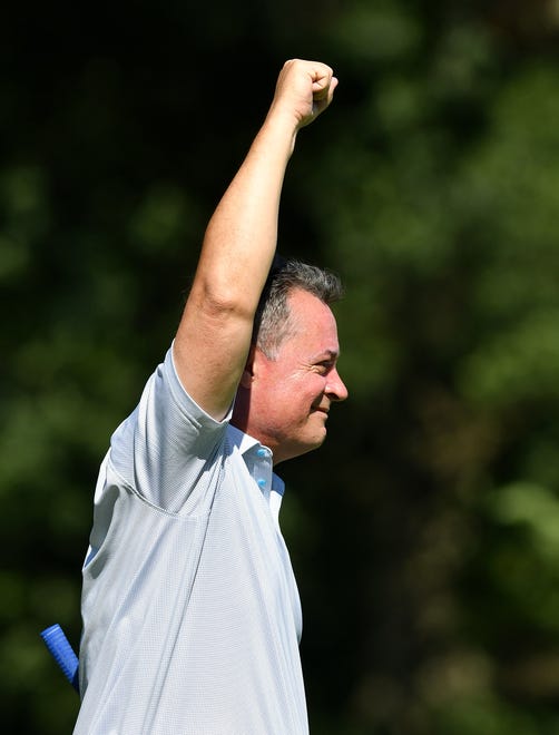 Belle Tire CEO Jack Lawless reacts after sinking a long putt on hole No. 14.