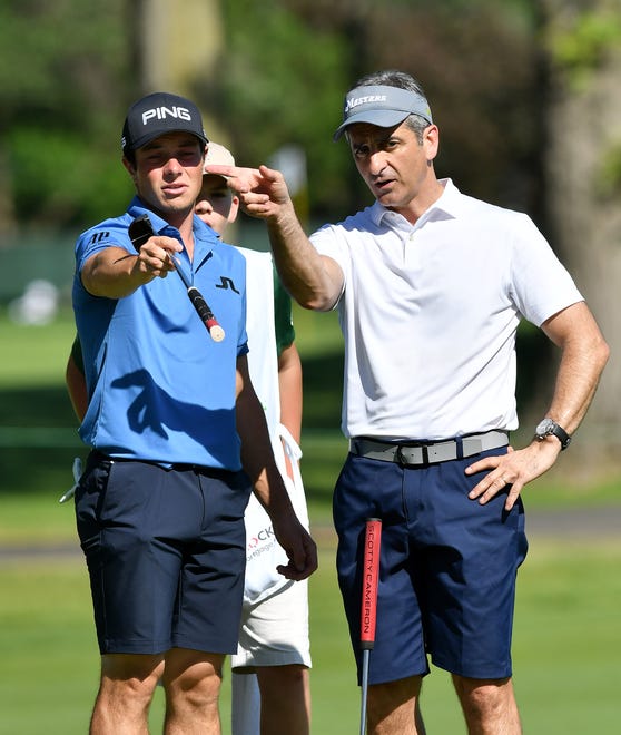 PGA golfer Viktor Hovland, left, and Dun & Bradstreet CEO Anthony Jabbour, right, talk between shots on hole No. 14.