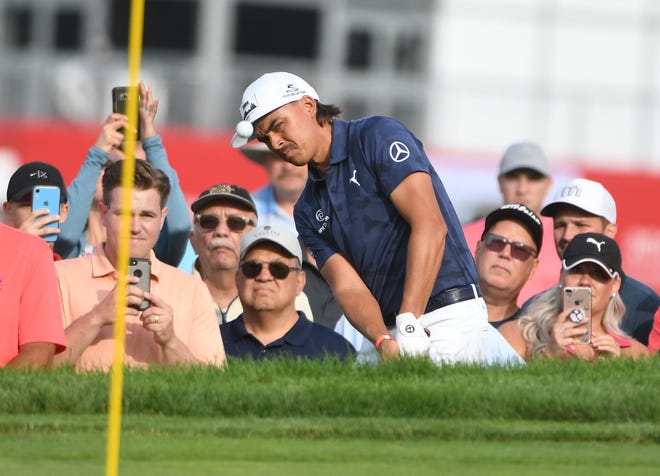 Rickie Fowler hits out of the rough along the 13th green during the first round of the Rocket Mortgage Classic at the Detroit Golf Club in Detroit, Michigan on June 27, 2019.