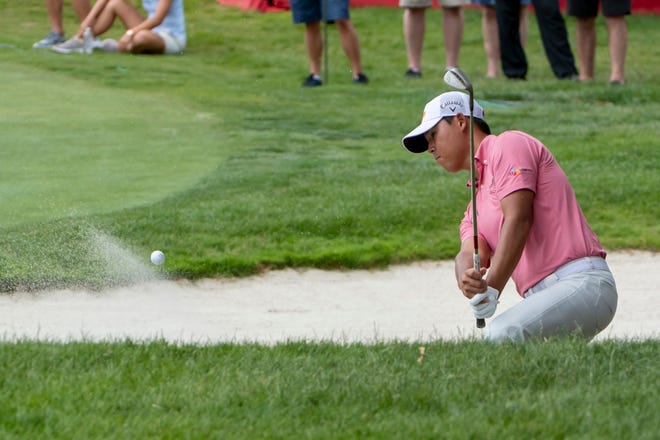 Si Woo Kim hits out of the bunker on the 18th hole.