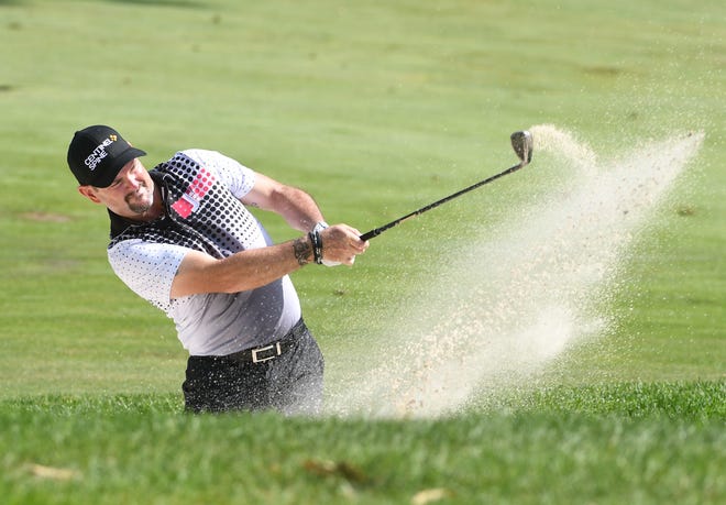 Rory Sabbatini hits out of a bunker on the 10th hole.