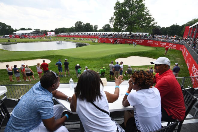 Golf fans enjoy the view from above the 14th green.