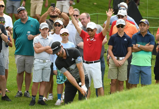 Dustin Johnson hits out of the rough, twice, near the fifth green.