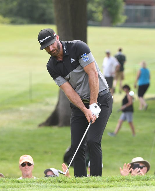 Dustin Johnson hits out of the rough, again, along the fifth green.
