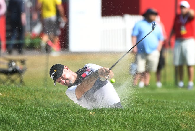 Rory Sabbatini hits out of a bunker on No. 10.