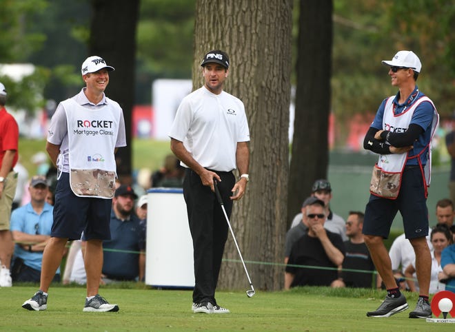 Bubba Watson jokes around with his caddie, right, and Billy Horschel's caddie, left, on the 11th tee.