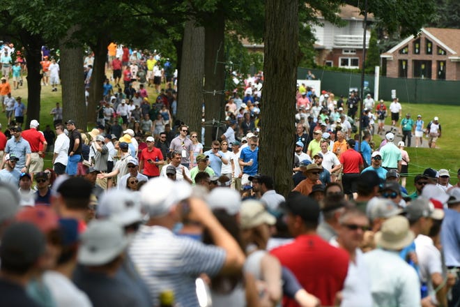Thousands of golf fans flood the eighth fairway for Round 3 on Saturday.