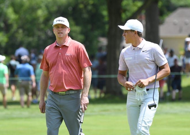 Nate Lashley, left, and Cameron Champ walk towards the fifth fairway.