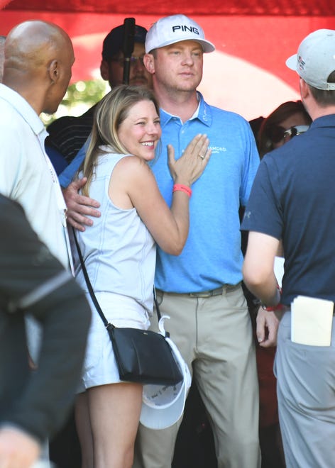 Brooke Lashley, left, hugs her brother Nate Lashley after his first PGA tournament win at the Rocket Mortgage Classic in Detroit Sunday.