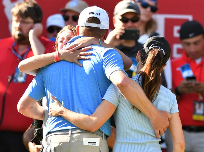 Nate Lashley is hugged by his sister Brooke, left facing, after his win at the Rocket Mortgage Classic.