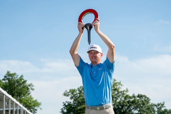 Nate Lashley holds the trophy after winning the Rocket Mortgage Classic golf tournament.