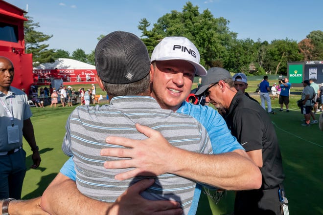 Nate Lashley receives hugs from friends and family after winning the Rocket Mortgage Classic in Detroit.