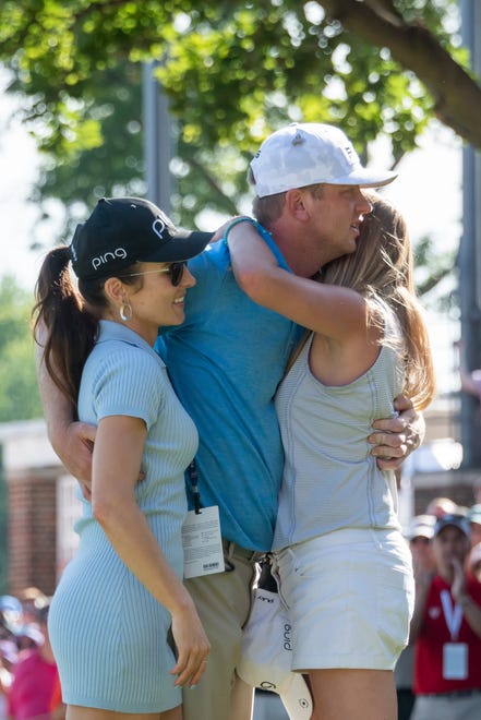 Nate Lashley hugs girlfriend Ashlie Reed, left, and sister Brooke Lashley after winning the Rocket Mortgage Classic golf tournament in Detroit.