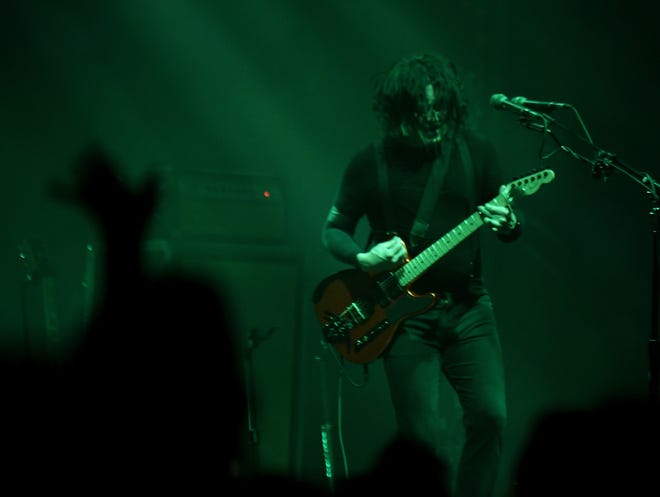 Jack White plays an energetic guitar as the Raconteurs play.